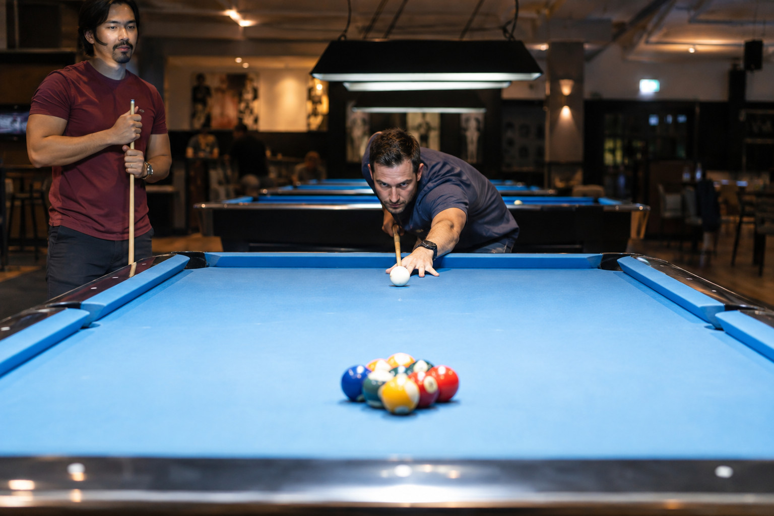 Player preparing to break a racked nine-ball game
