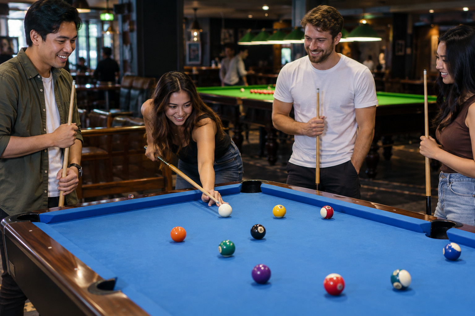 Four friends enjoying a casual game on a blue pool table