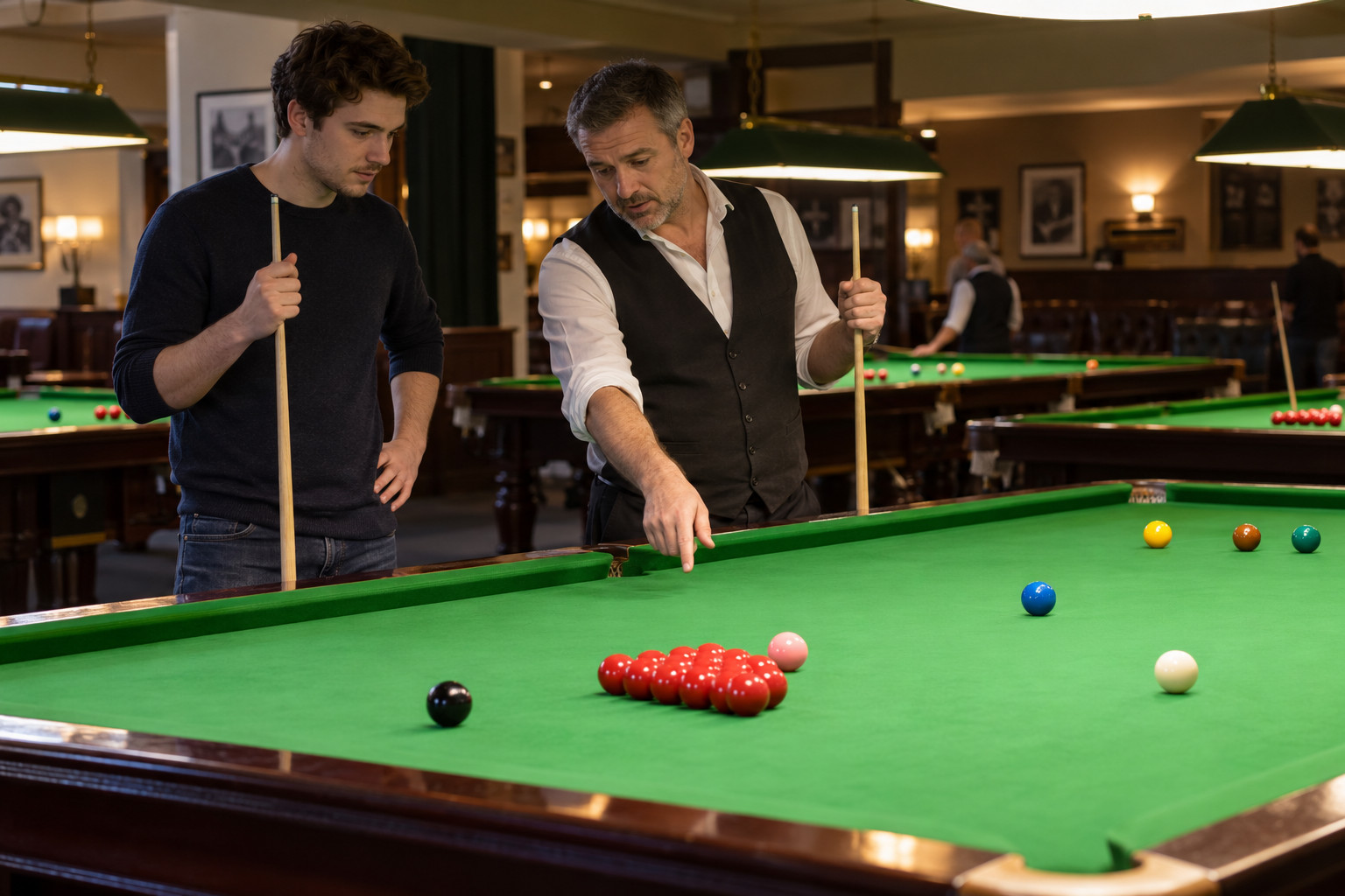 Experienced player explaining snooker ball positions to a newcomer